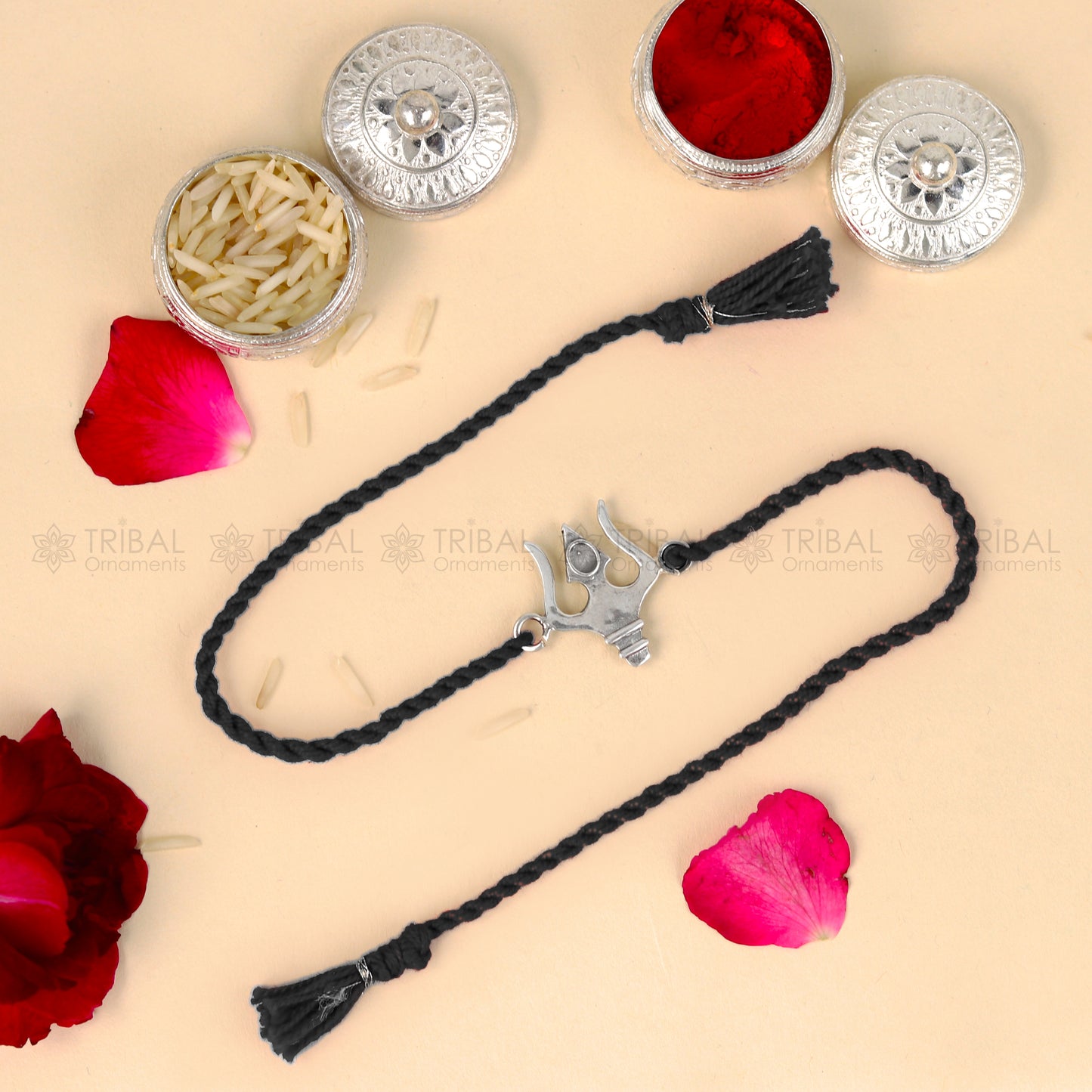 Sterling silver Trishul thread rakhi bracelet by TRIBAL ORNAMENTS featuring a Trident design on a braided thread.