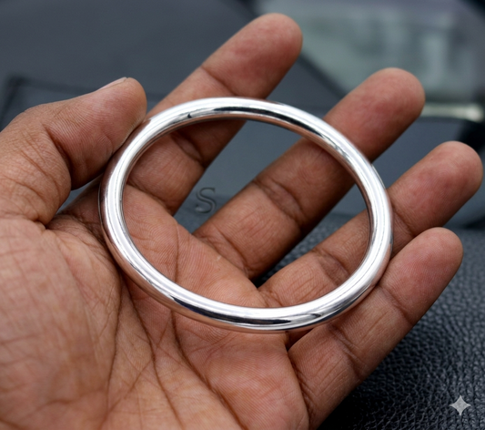 Bright shining 925 sterling silver unisex round bangle bracelet with intricate handmade design from TRIBAL ORNAMENTS.