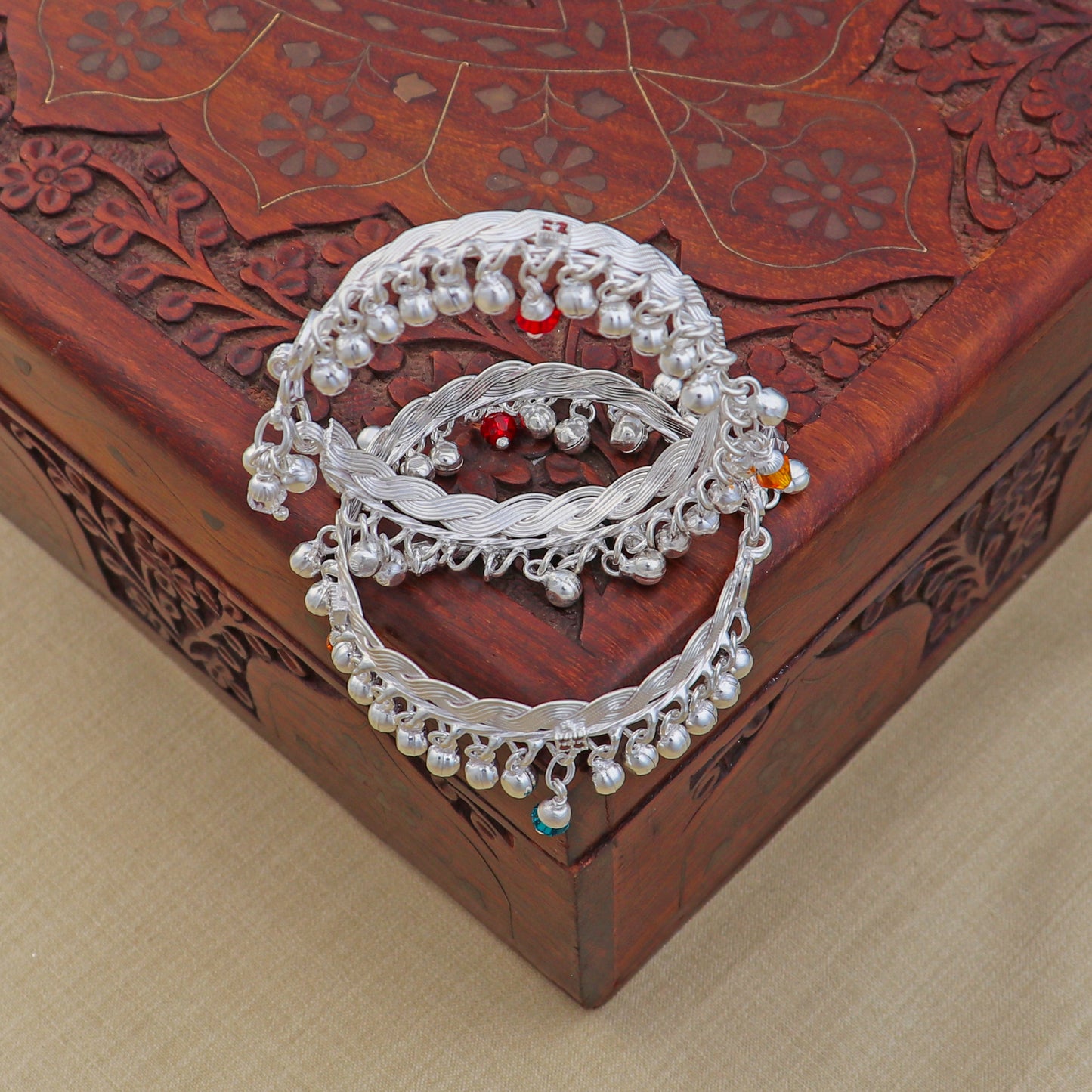 Sterling silver customized baby anklet with jingling charms, featuring delicate design for kids from TRIBAL ORNAMENTS.