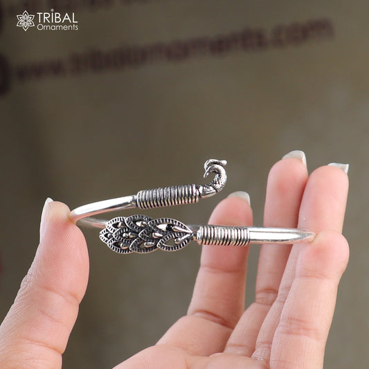 Sterling silver peacock-style bangle bracelet with intricate design, easy to wear tribal jewelry for women.