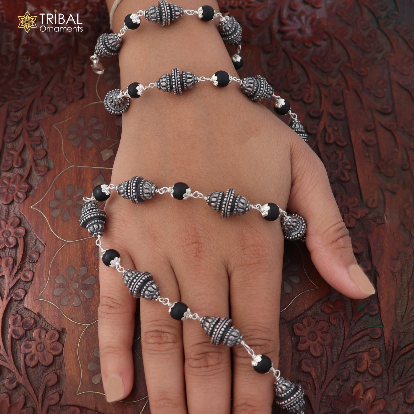 Vintage sterling silver necklace with Karungali beads, featuring intricate silver design by TRIBAL ORNAMENTS.