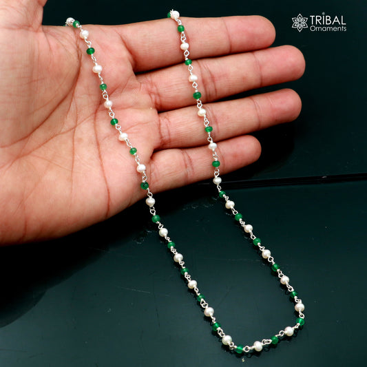Sterling silver beaded chain with pearls and green stones, jewelry piece by TRIBAL ORNAMENTS, featuring intricate beadwork and vibrant accents.