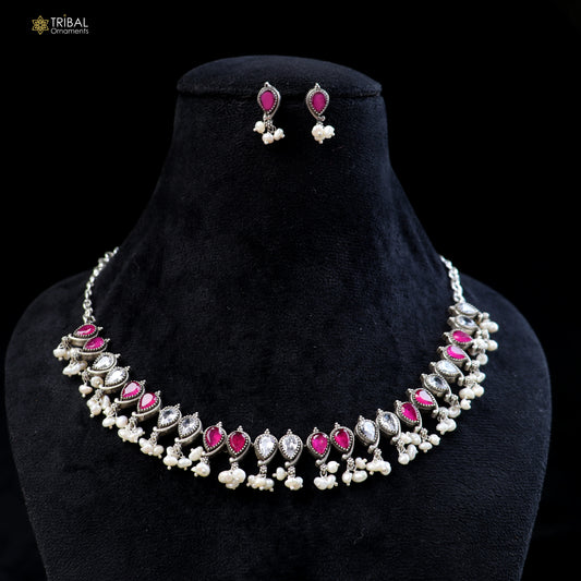 Sterling silver ruby red and white cut stone necklace and earrings set from Tribal Ornaments, oxidized ethnic jewelry with intricate design.