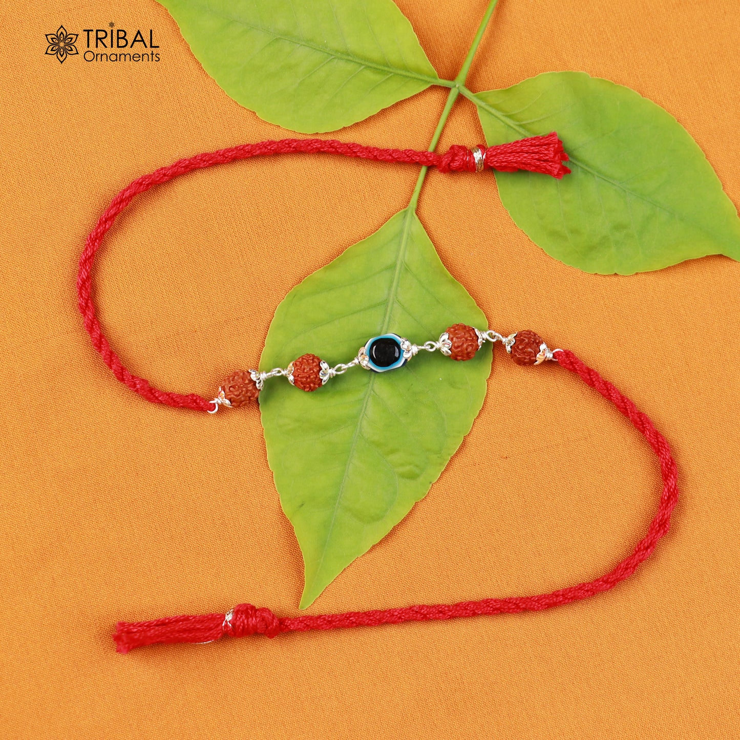 Sterling silver Rudraksha and evil eye beads red thread Rakhi bracelet with intricate design for special occasions.
