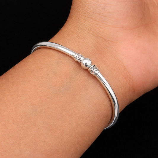 Shiny sterling silver round bangle bracelet with a sleek plain design, ideal for brides and stylish jewelry looks.