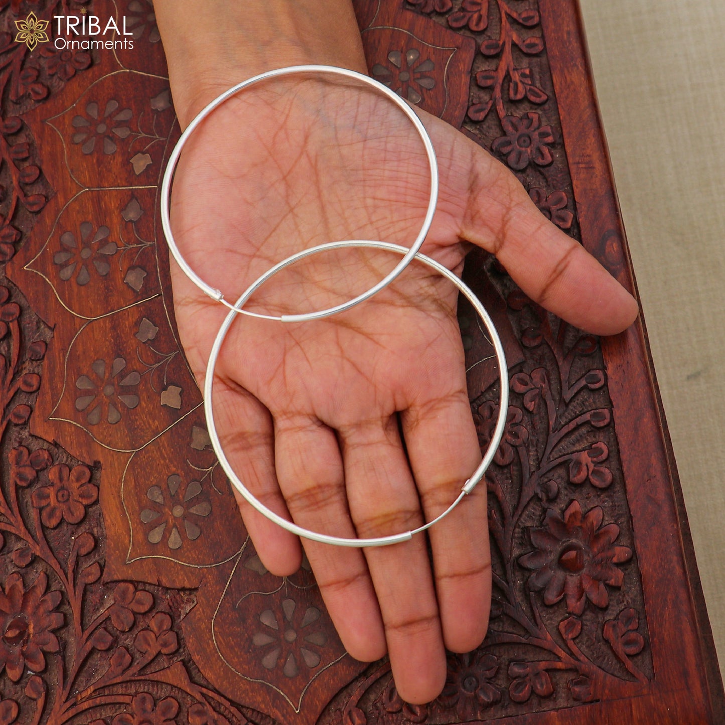Elegant 925 sterling silver round hoops earrings with polished finish, crafted by TRIBAL ORNAMENTS.
