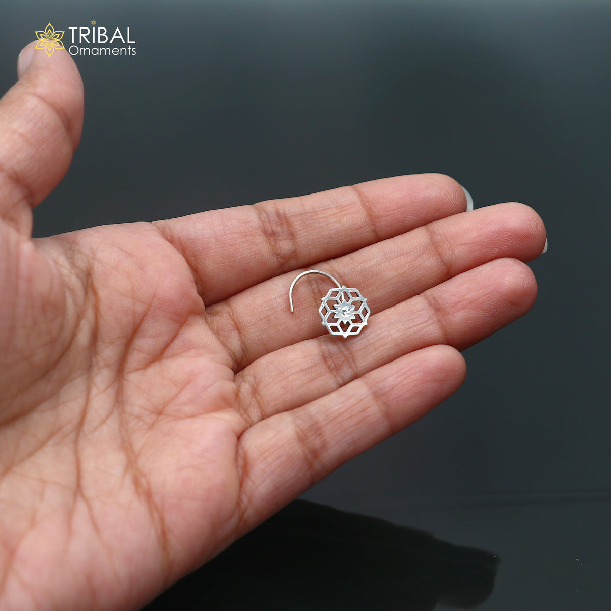 Sterling silver vintage star-style nose pin with tribal design, ethnic jewelry by TRIBAL ORNAMENTS, shown in close-up image.