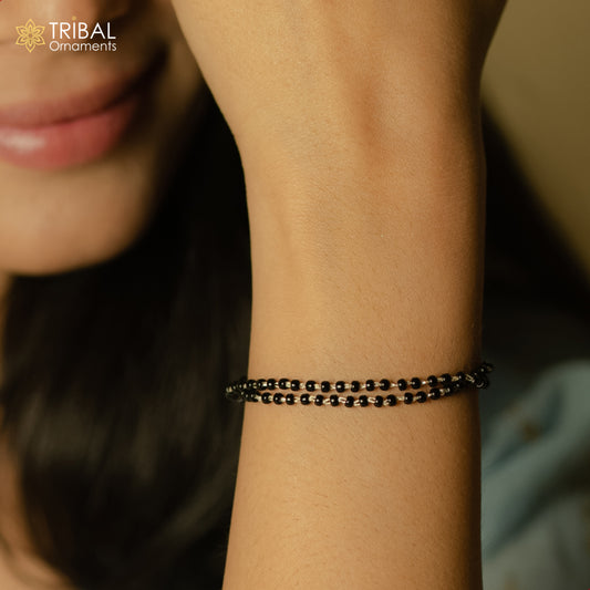 Sterling silver 2-layer charm bracelet with black beads from TRIBAL ORNAMENTS, featuring 2.5 mm black beads and handcrafted design.