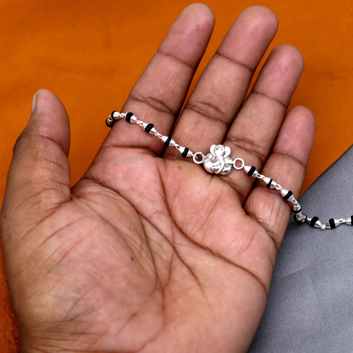 925 sterling silver Lord Ganesha black Tulsi beaded bracelet with handmade design and holy basil beads by TRIBAL ORNAMENTS.