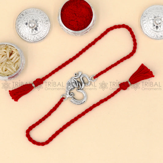 925 Sterling silver Ganesha Om thread rakhi bracelet with red thread and intricate pendant design by TRIBAL ORNAMENTS