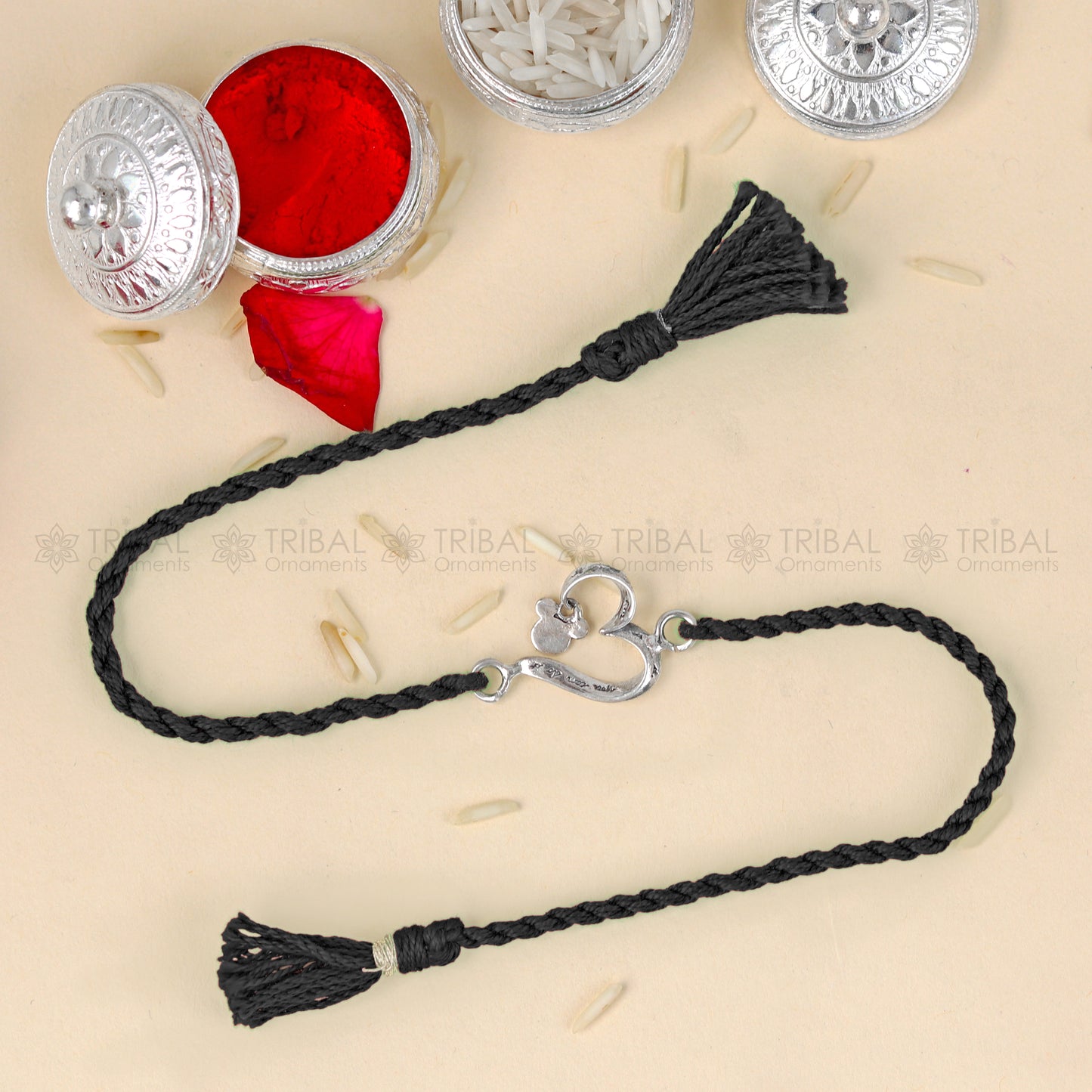925 Sterling silver heart design thread rakhi bracelet with red thread from TRIBAL ORNAMENTS, featuring a silver heart pendant.