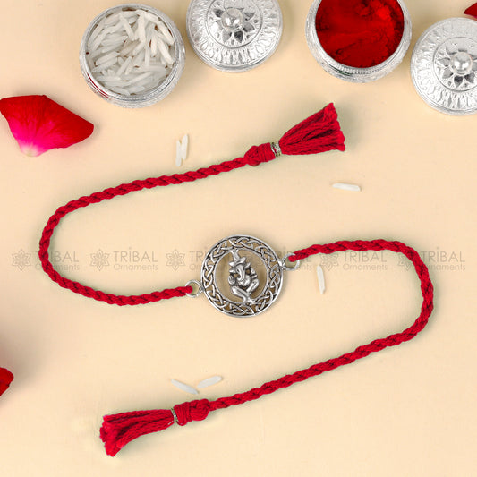 Sterling silver Lord Ganesha design thread bracelet with red thread, crafted by TRIBAL ORNAMENTS.