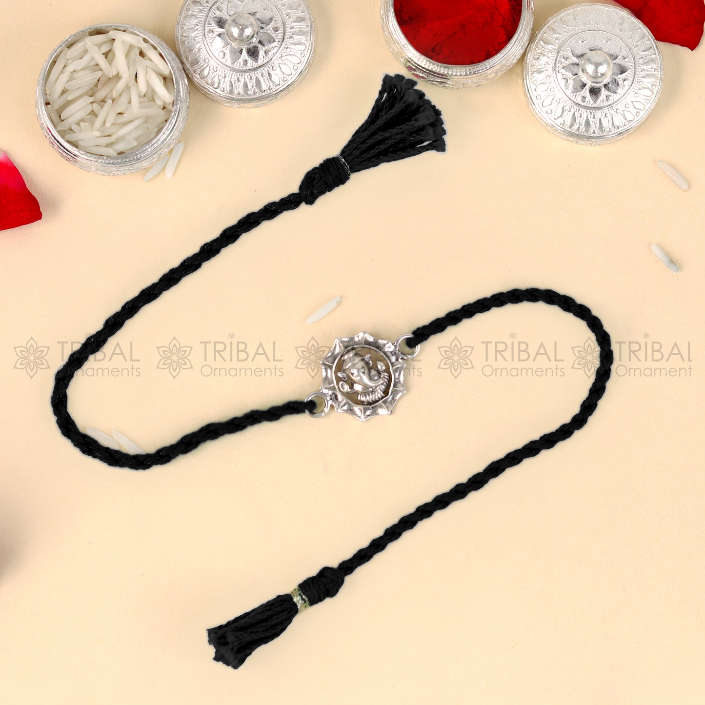 Sterling silver Lord Ganesha design thread bracelet with red thread from TRIBAL ORNAMENTS featuring a detailed Ganesha pendant.
