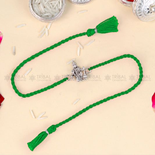 Sterling silver Lord Hanuman ji design thread rakhi bracelet with red thread from Tribal Ornaments, featuring intricate pendant detail.