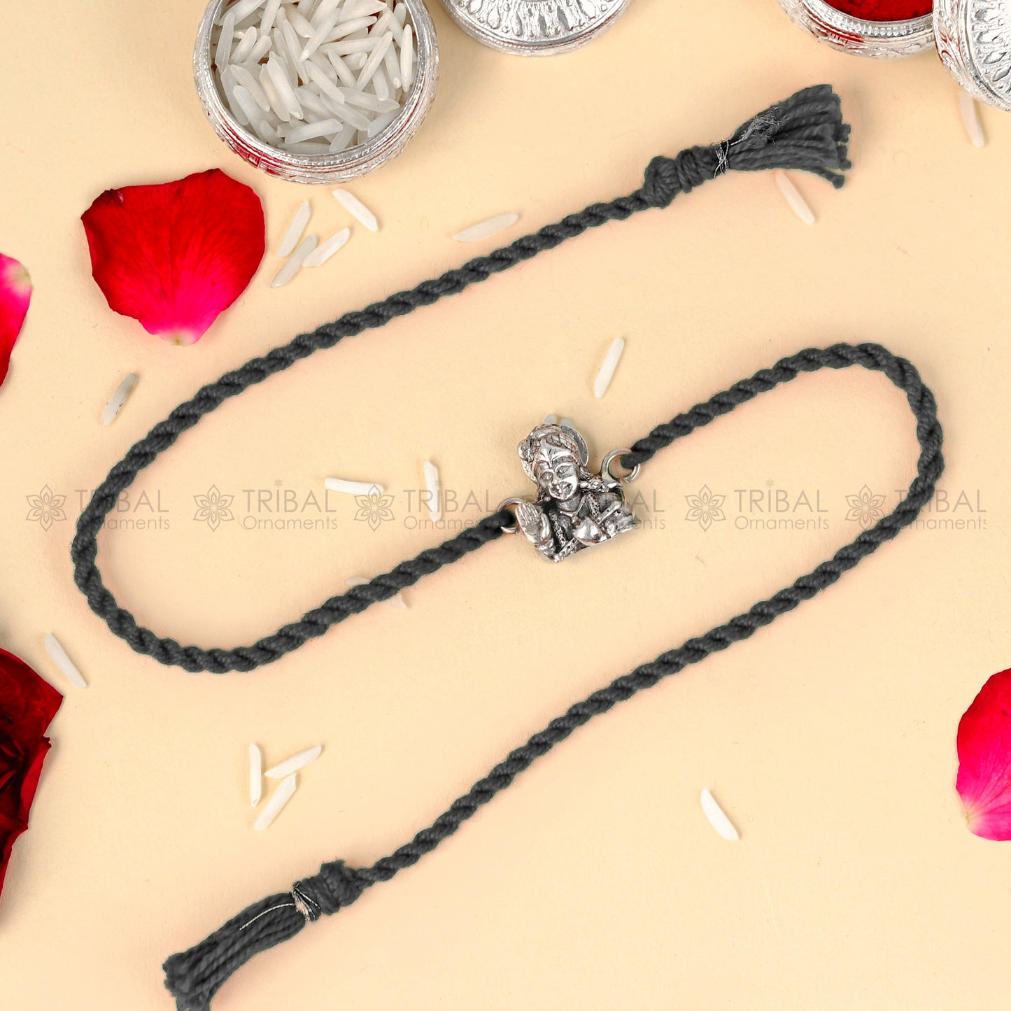 Sterling silver Lord Krishna design thread bracelet by TRIBAL ORNAMENTS with red thread and intricate Krishna pendant.