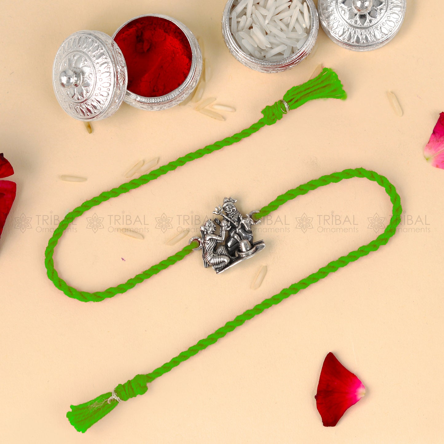 Sterling silver Lord Parwati and Nandi Maharaj bracelet with Shiva Lingam design on red thread, from Tribal Ornaments.