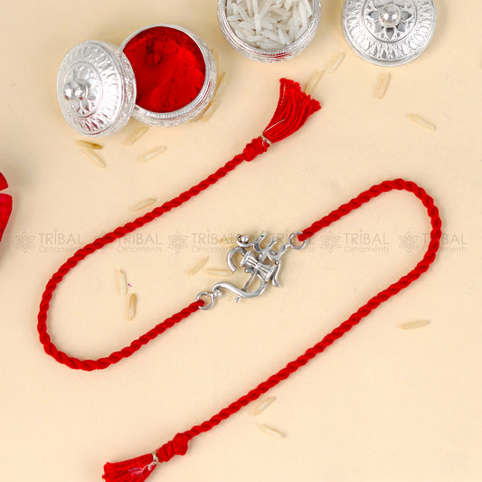 Sterling silver Om with trishul design thread bracelet by Tribal Ornaments on red thread, featuring intricate silver pendant.