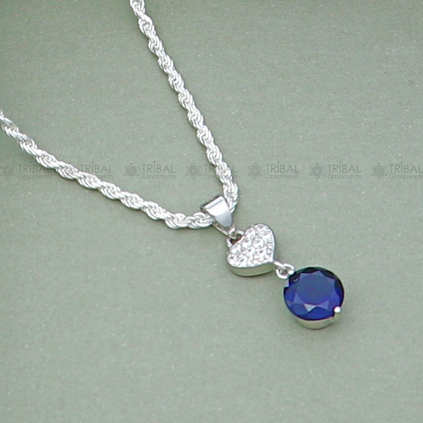 925 Sterling silver pendant set featuring a round blue sapphire diamond, showcasing a sleek and elegant jewelry design.