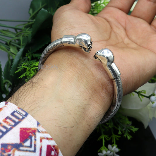 Sterling silver human skull design bangle cuff for unisex, handmade by TRIBAL ORNAMENTS, featuring detailed skull artwork.