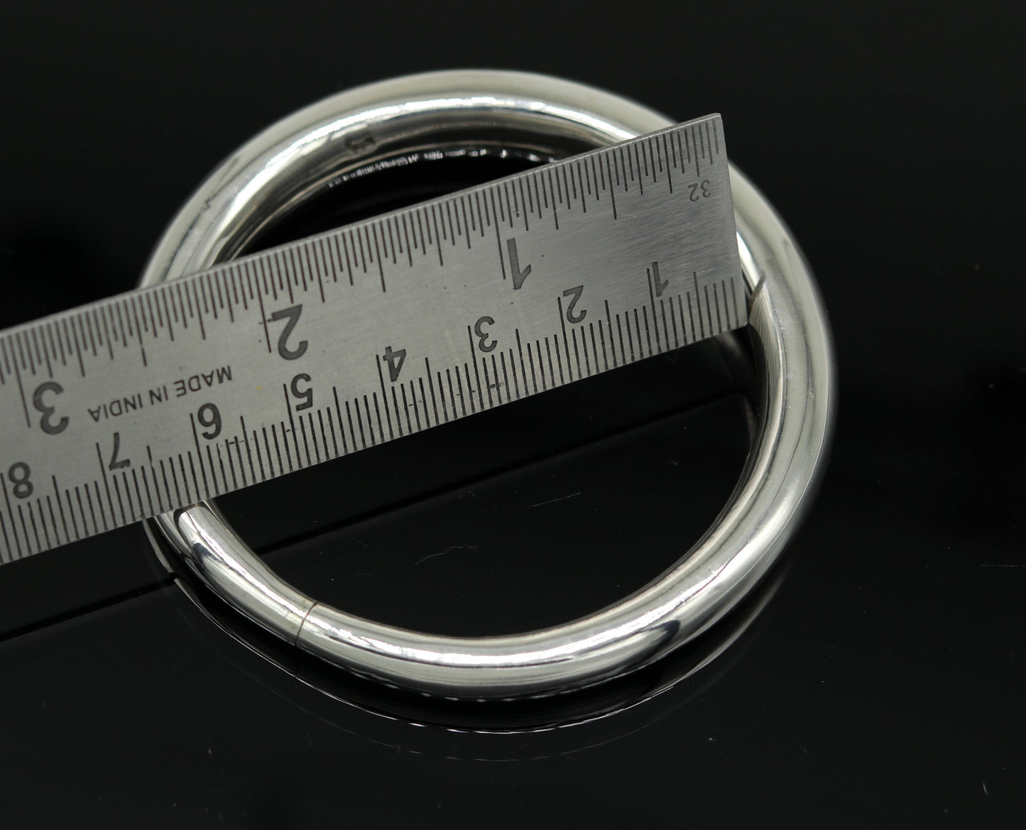 Sterling silver vintage open face bangle bracelet by Tribal Ornaments, handmade, adjustable unisex cuff jewelry for gifting in India.