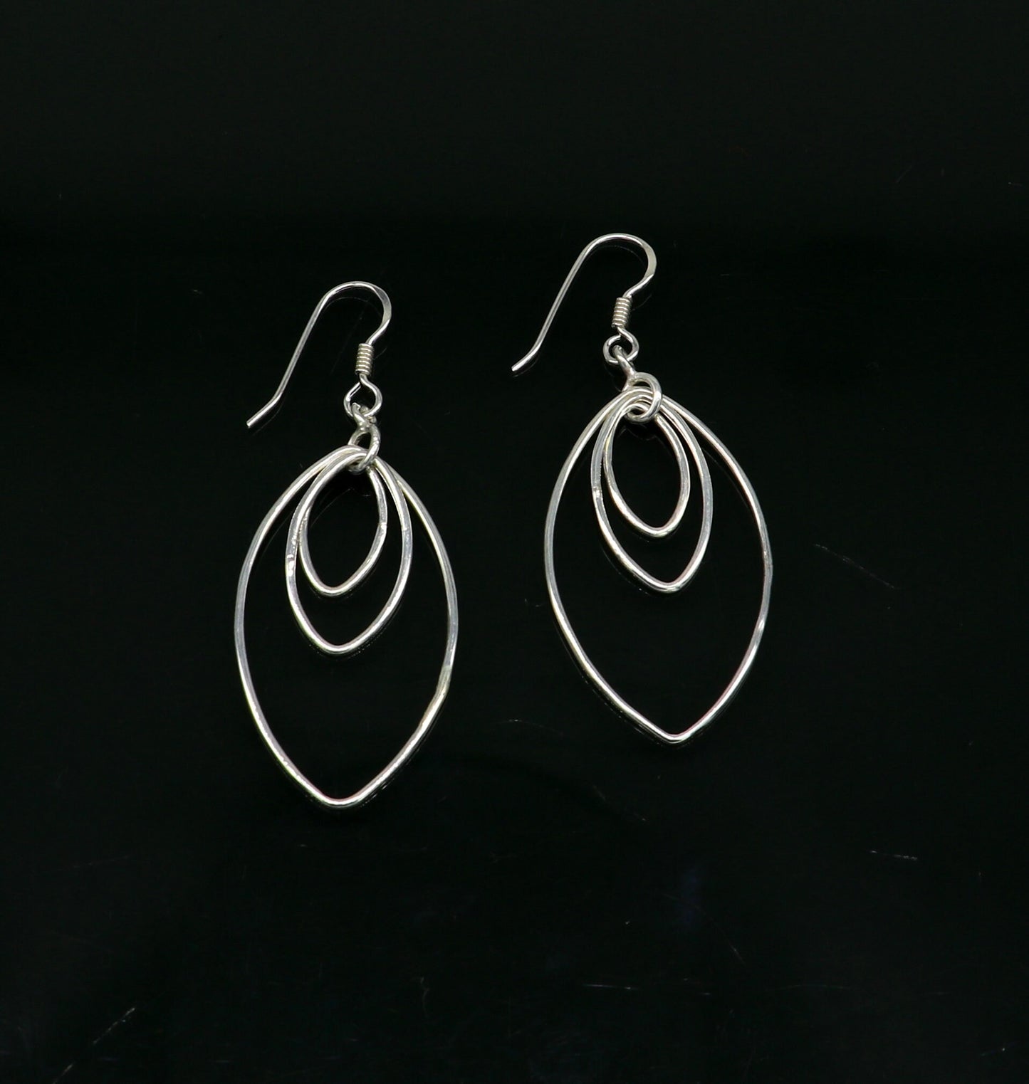 Sterling silver handmade eclipse style hoop earring with drop dangle geometric design by TRIBAL ORNAMENTS for elegant, trendy jewelry.