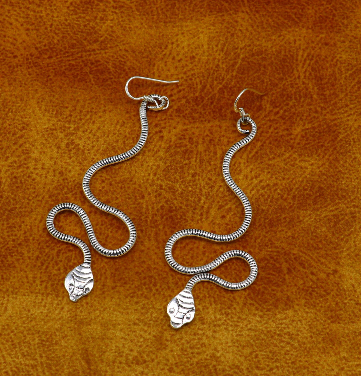 Sterling silver handmade snake design hoop earring by TRIBAL ORNAMENTS, vintage and stylish bridal jewelry with unique antique charm.