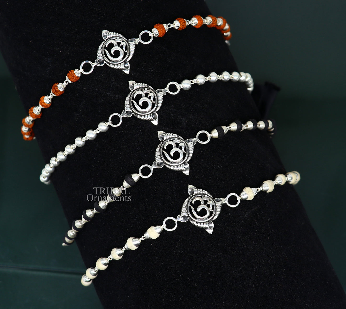 Sterling silver OM design Rudraksha and Tulsi beads bracelet, handmade tribal-style rakhi with intricate details and spiritual symbols.