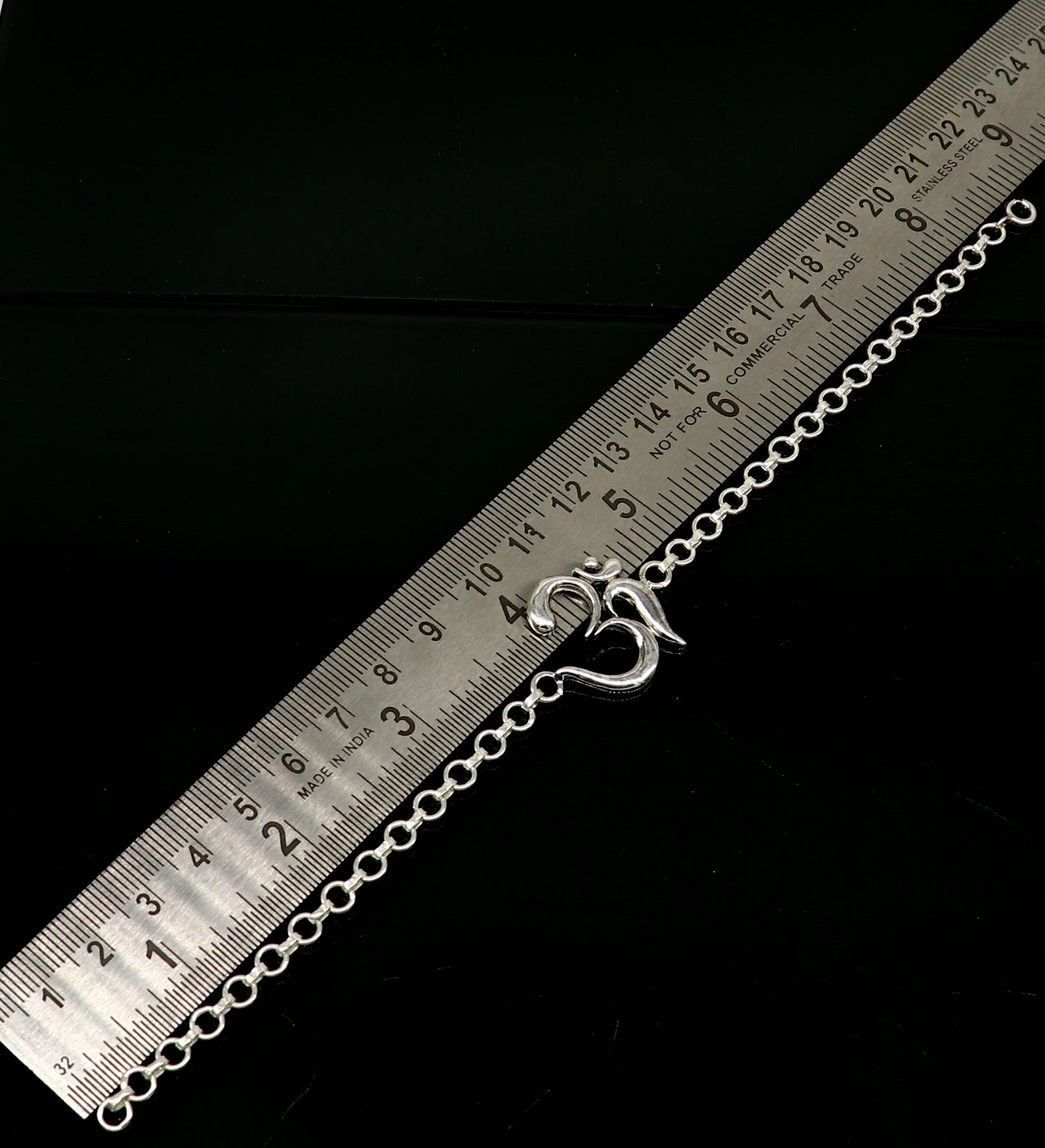Sterling silver OM mantra bracelet by TRIBAL ORNAMENTS, handmade 7-inch bracelet with intricate Aum design.
