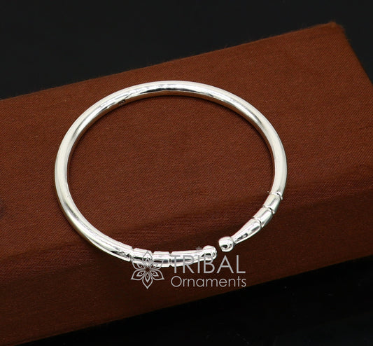 Sterling silver handmade bangle bracelet with a plain, shiny finish, adjustable design, unisex modern jewelry by Tribal Ornaments.