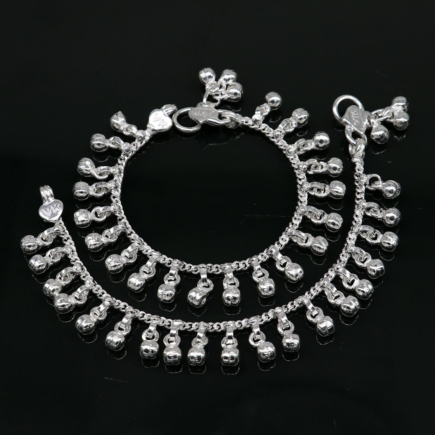 Sterling silver vintage baby anklet with 5.5-inch waved hanging bells, handmade tribal design, and charm accents.
