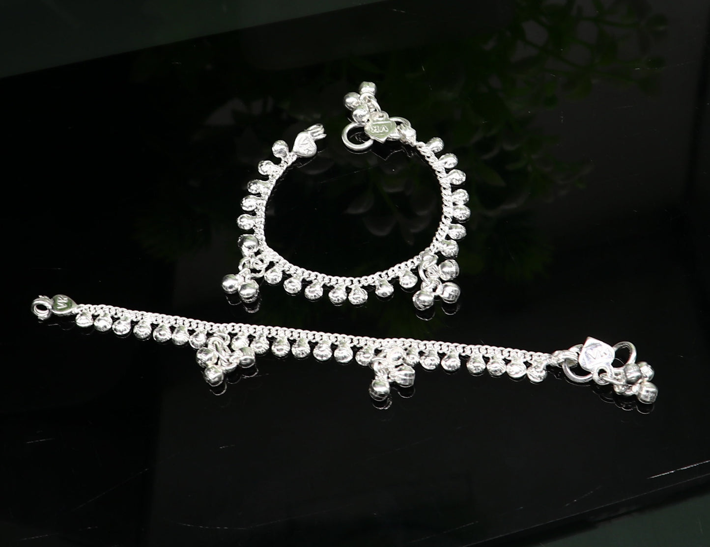 Handmade 5-inch sterling silver baby ankle bracelet with dainty charms, unisex and customizable, from Tribal Ornaments.