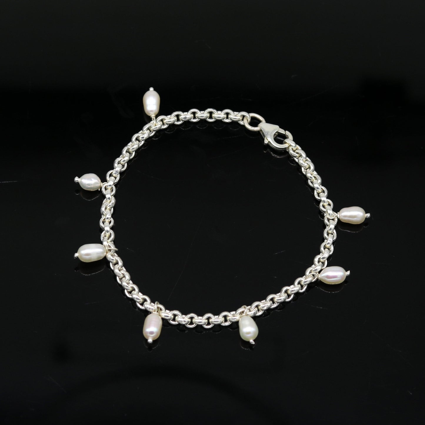 Sterling silver customized charm pearl bracelet by Tribal Ornaments, featuring handcrafted design and stylish unisex jewelry.