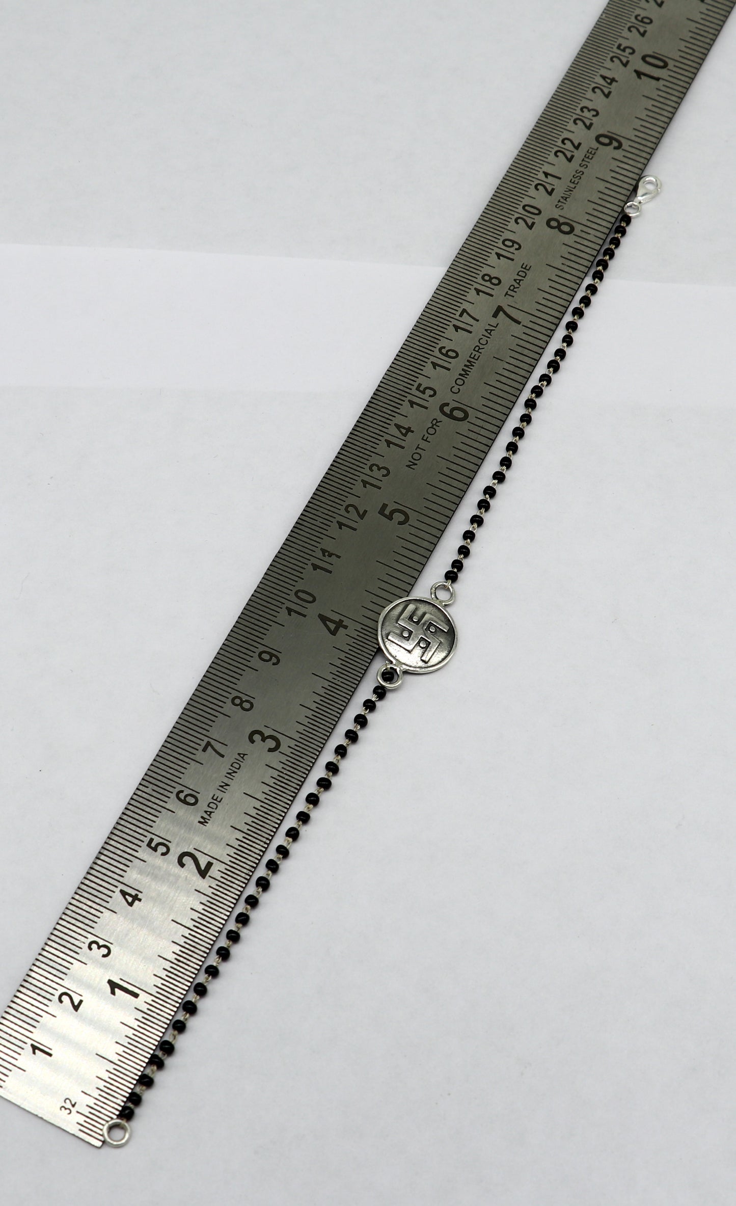 Sterling silver 8.5-inch black beaded Swastik bracelet by TRIBAL ORNAMENTS featuring customizable design and intricate beaded details.