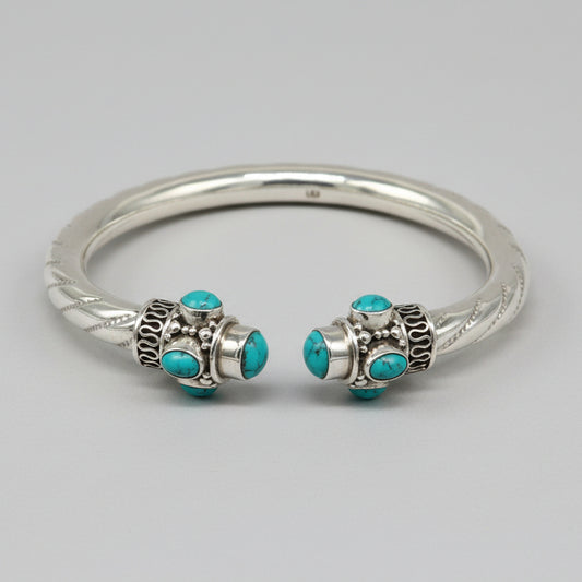 Sterling silver cuff bangle with vibrant blue turquoise stone, handcrafted tribal jewelry by TRIBAL ORNAMENTS, stylish and customizable.