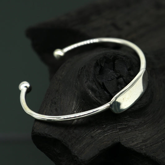 Sterling silver baby bangle bracelet with a bright, plain design, perfect as a gift for newborns from TRIBAL ORNAMENTS.
