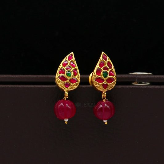 Sterling silver gold-polished kundan flower-shaped stud earrings with green and red stones, modern trendy jewelry by TRIBAL ORNAMENTS.