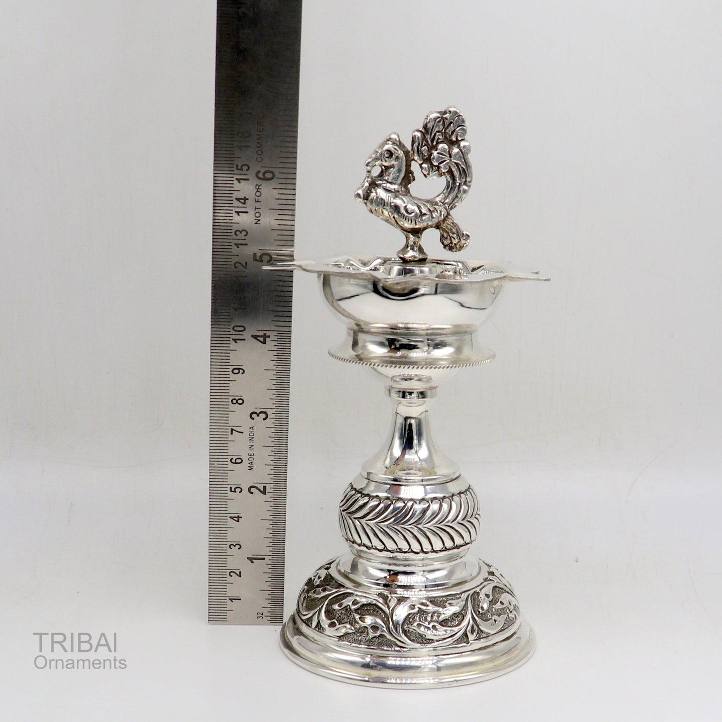 Handcrafted 925 sterling silver vintage oil lamp or candle stand with detailed silver Deepak and puja utensils, traditional silver figurine.