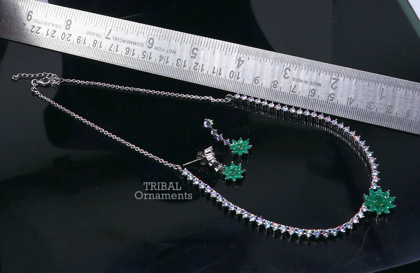Sterling silver necklace with green cubic zirconia stones, intricate tribal jewelry design, perfect for wedding or bridal occasions.