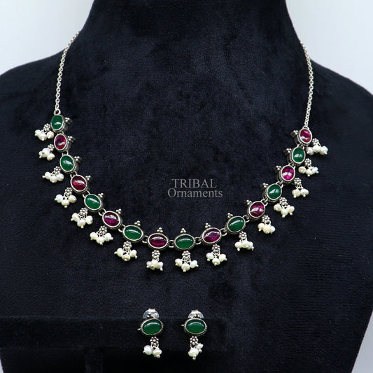 Sterling silver necklace with red and green stones, pearls, and intricate tribal design for wedding or special occasions.