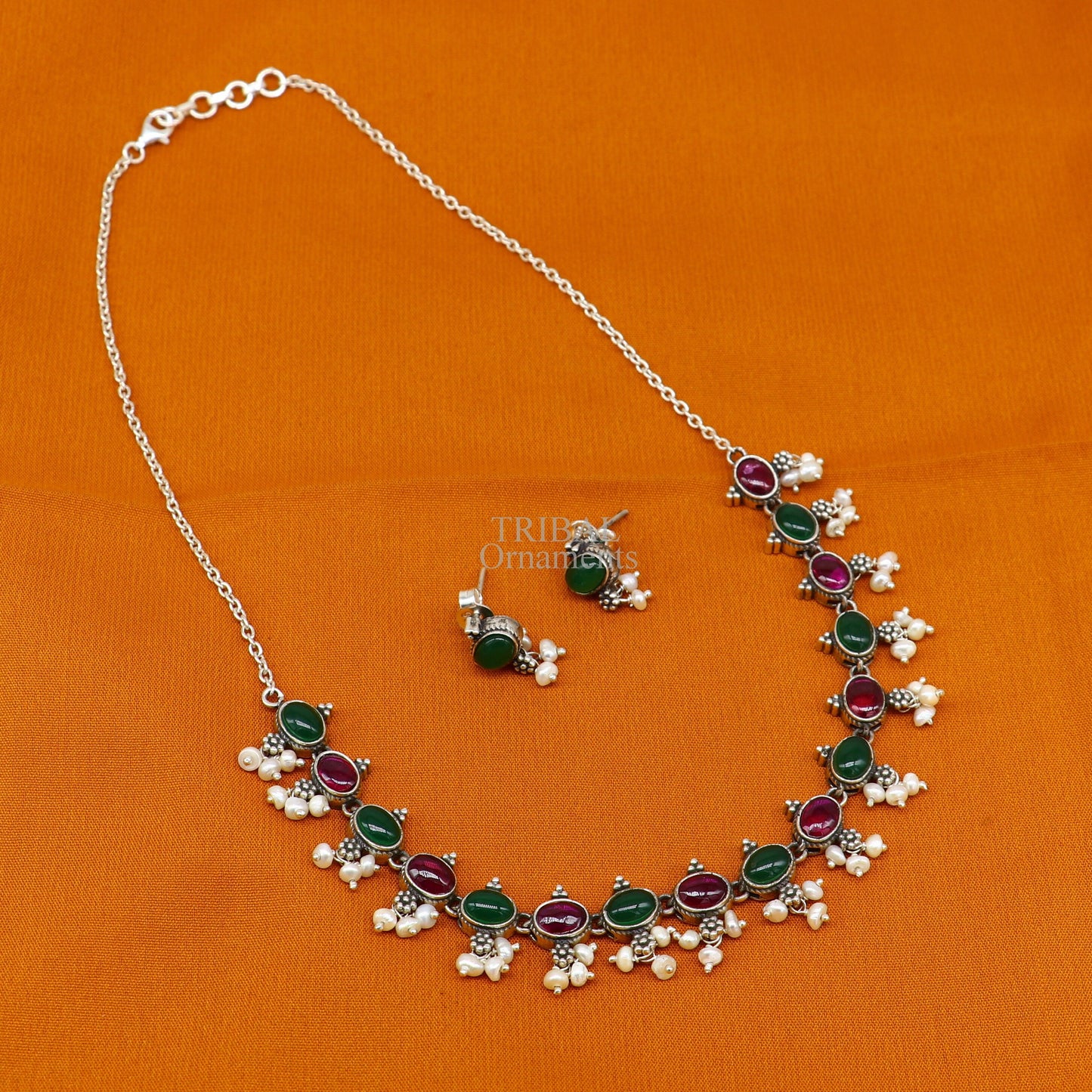Sterling silver necklace with red and green stones, pearls, and charm, crafted by TRIBAL ORNAMENTS for wedding or bridal jewelry.