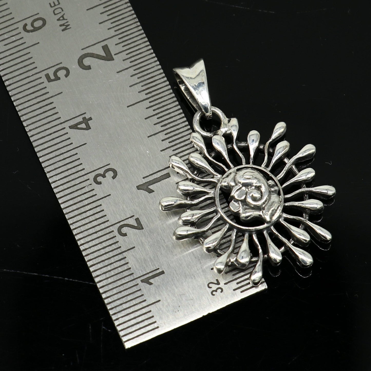 Sterling silver Ganesha floral pendant by TRIBAL ORNAMENTS, handcrafted unisex jewelry with intricate design and personalized style.