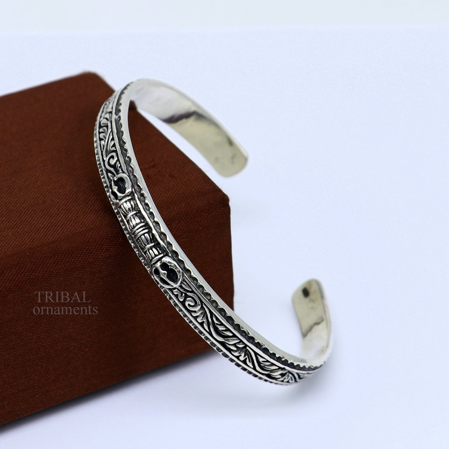 Sterling silver vintage Vajra design bangle cuff bracelet by TRIBAL ORNAMENTS, with intricate tribal and unisex jewelry details.
