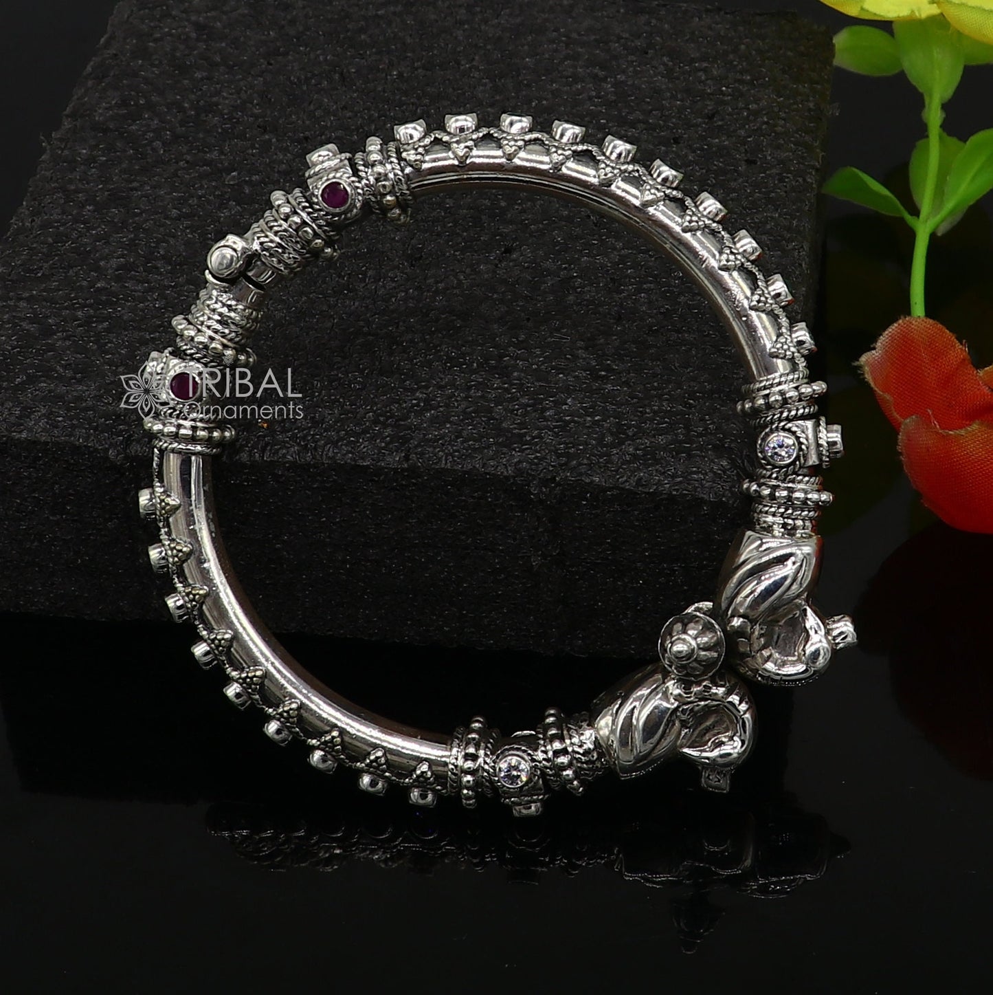 Sterling silver peacock design bangle bracelet with cubic zircon stones from TRIBAL ORNAMENTS, showcasing intricate craftsmanship.