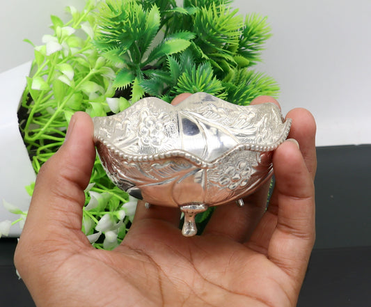 Vintage 999 fine silver worshipping puja bowl with intricate design, used for prasadam and idols like Krishna in religious rituals.