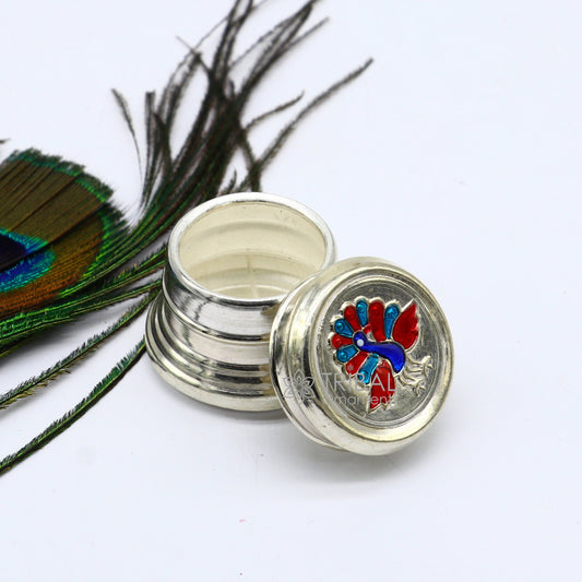 Pure silver trinket box with peacock design, round shape, ideal for brides, containing kajal, sindur, or small jewelry.
