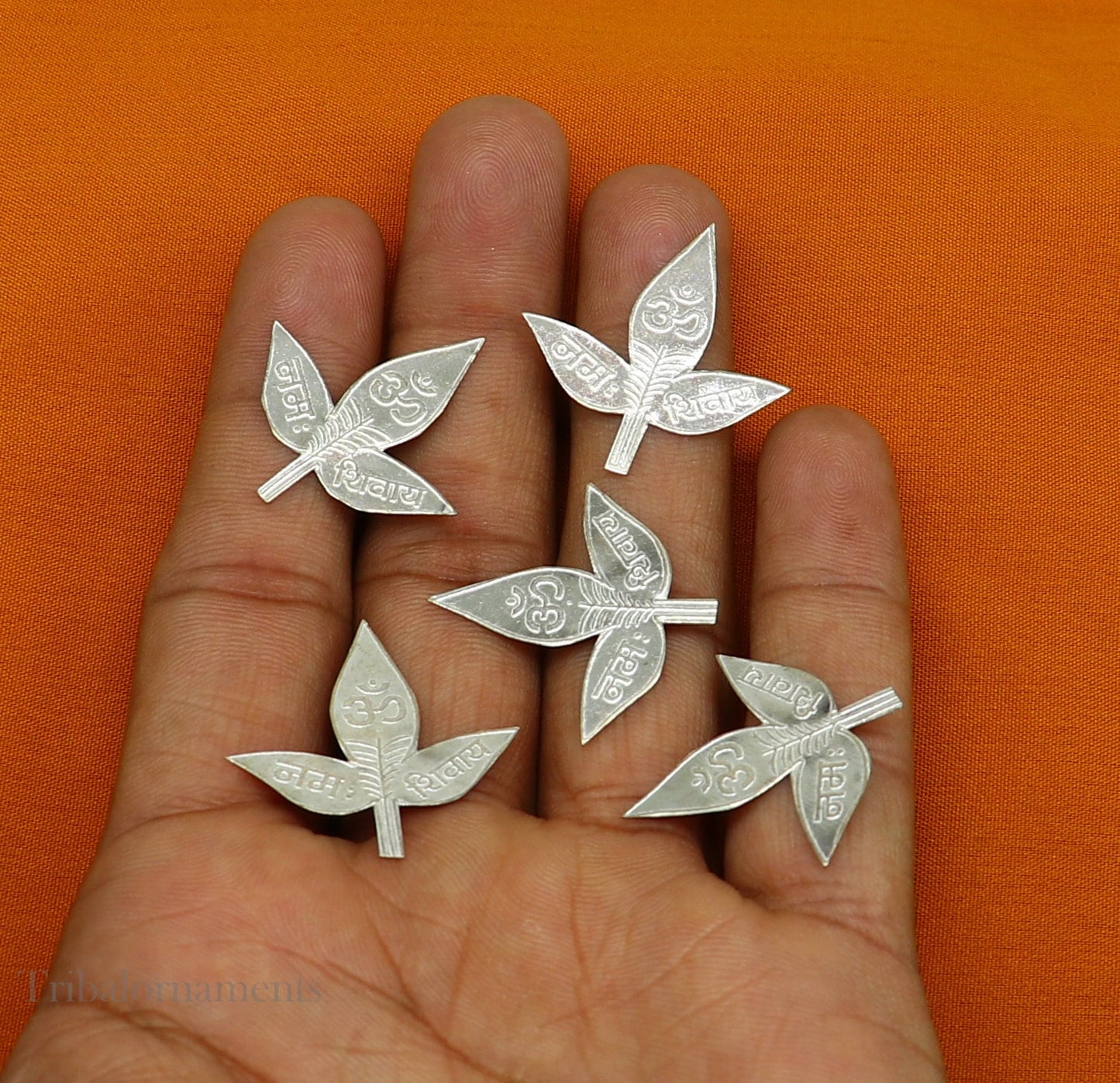 Set of 5 solid silver handmade belva patra leaves for Shiva worship, featuring shiva mantras, crafted by Tribal Ornaments.