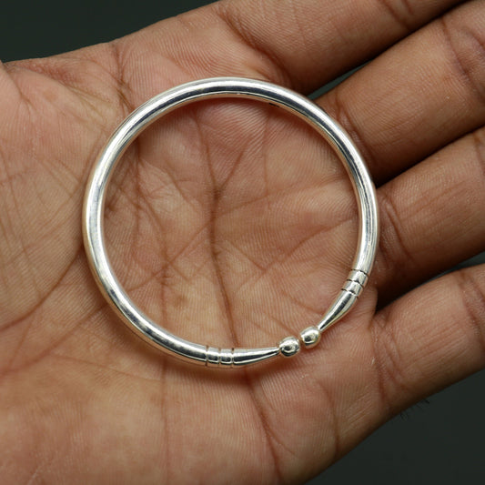 Sterling silver baby bangle by TRIBAL ORNAMENTS featuring a plain shiny design, adjustable baby bracelet for newborns.