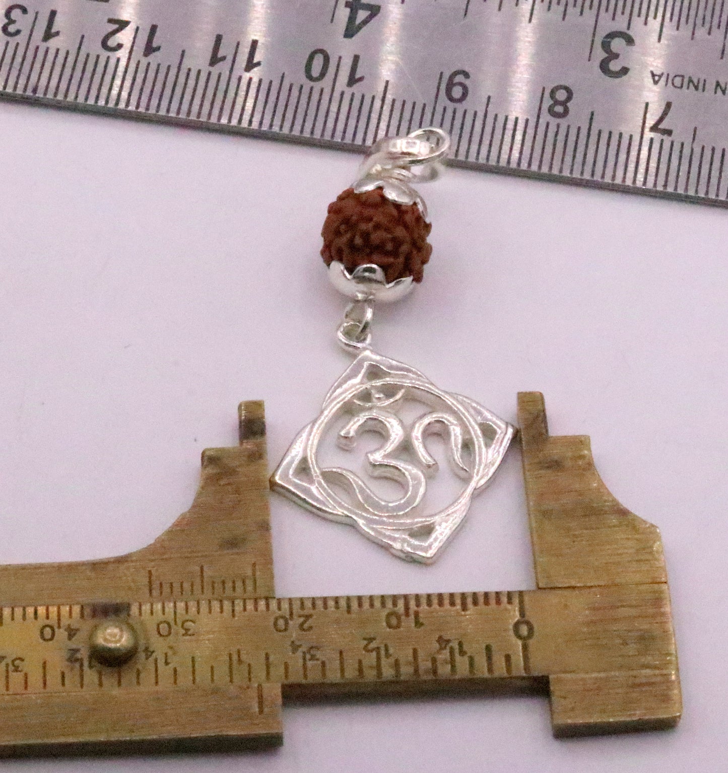 Vintage solid silver Aum pendant with natural Rudraksh beads, handmade tribal jewelry design.