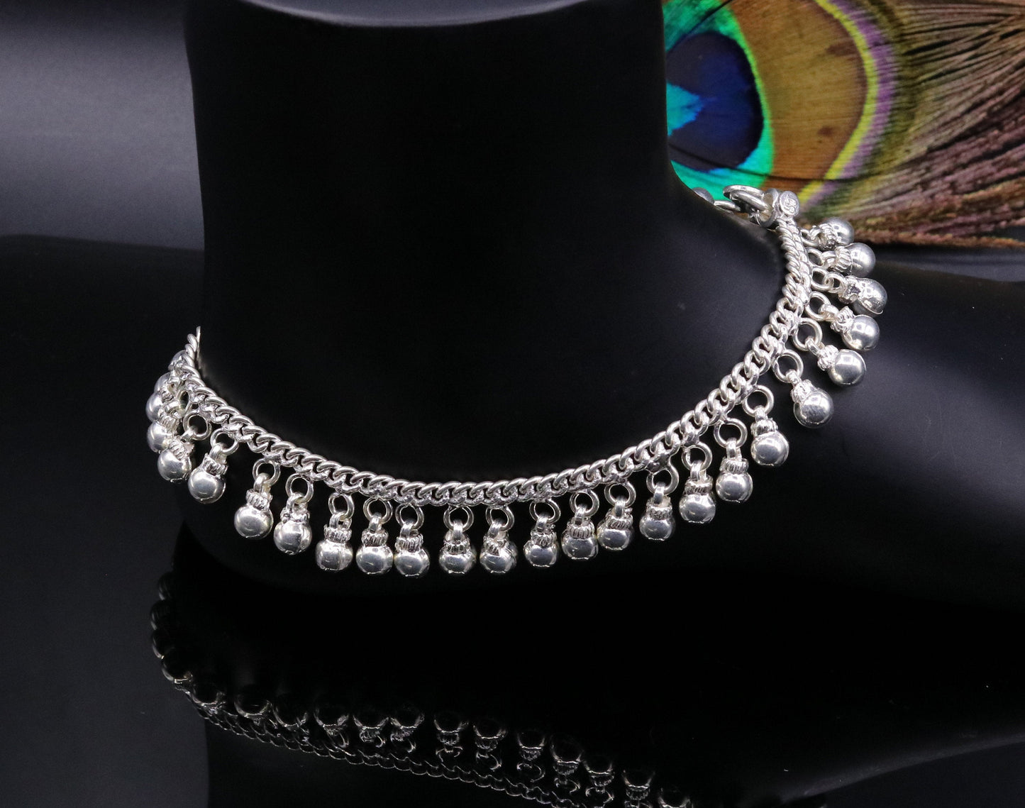 Vintage sterling silver ankle bracelet with handmade chain and noisy jingle bells, featuring tribal-inspired design and genuine jewelry appeal.