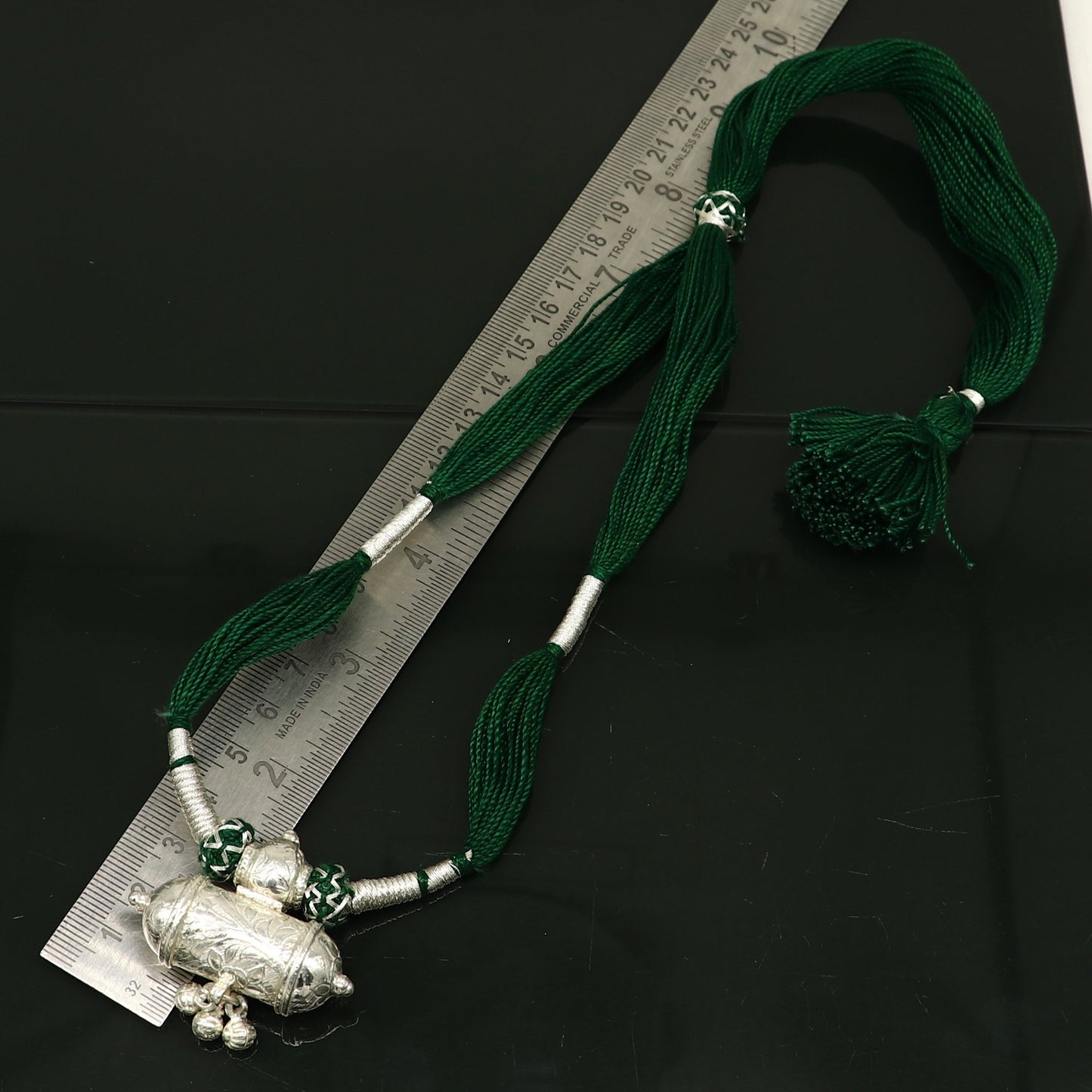 Vintage Indian silver charm necklace with green thread, traditional tribal wedding jewelry, ethnic tribal ornaments.